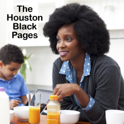 Beautiful professional African American mother in kitchen dressed in suit ready for work